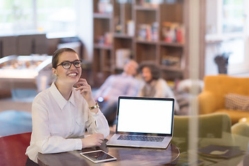 Image showing businesswoman using a laptop in startup office