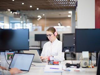 Image showing businesswoman using a laptop in startup office