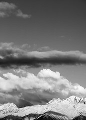 Image showing Black and white view on snow winter mountains in clouds at sun e