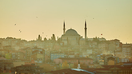 Image showing Silhouette of a Mosque Fatih in a fog and sunlight reflections. Vintage style.