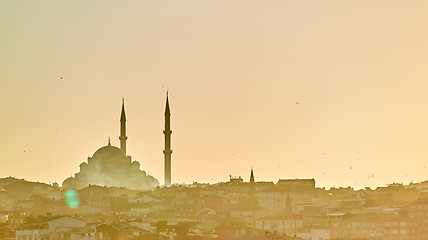 Image showing Silhouette of a Mosque Fatih in a fog and sunlight reflections. Vintage style.