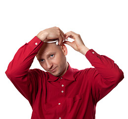 Image showing Young man in red shirt puts on head headset EEG (electroencephal