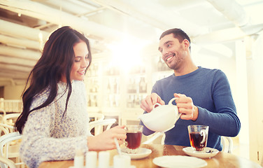 Image showing happy couple drinking tea at cafe