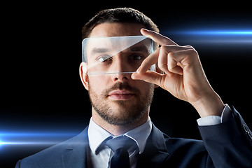 Image showing businessman with transparent smartphone