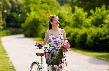 Image showing happy woman riding fixie bicycle in summer park