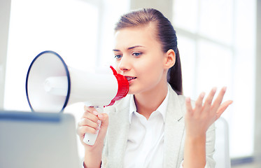 Image showing strict businesswoman shouting in megaphone