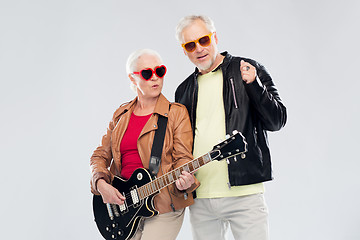 Image showing senior couple in sunglasses with electric guitar