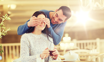 Image showing happy couple drinking tea at cafe