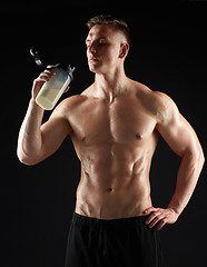 Image showing young man or bodybuilder with protein shake bottle