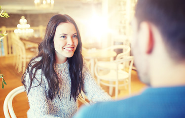Image showing happy couple talking at cafe or restaurant