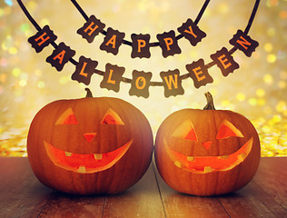 Image showing carved pumpkins and happy halloween garland