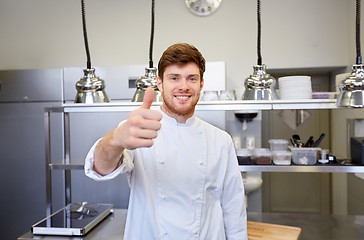 Image showing happy chef at restaurant kitchen showing thumbs up
