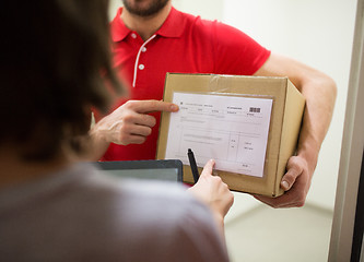 Image showing delivery man with box, tablet pc and customer