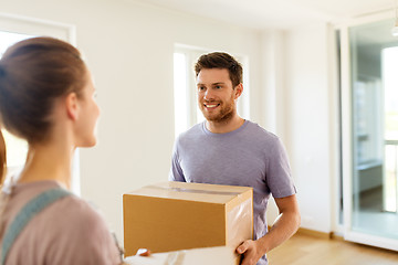 Image showing happy couple with boxes moving to new home