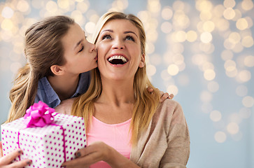 Image showing girl giving birthday present to mother over lights