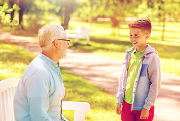 Image showing grandfather and grandson talking at summer park