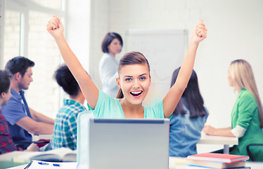 Image showing happy student girl with laptop at school