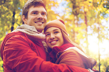 Image showing happy young couple hugging in autumn park