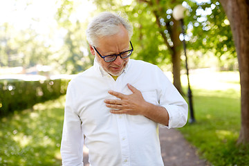 Image showing senior man feeling sick at summer park