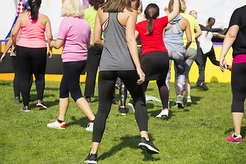 Image showing Group of young girls exercising fitness with dancing in the city