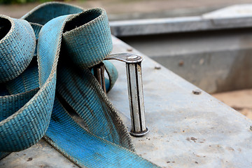 Image showing Detail of metal buckle on a blue ratchet strap