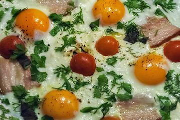 Image showing Scrambled eggs with bacon and tomatoes.