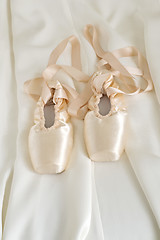 Image showing Ballet pointe shoes on beige color fabric