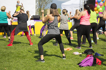 Image showing Group of young girls exercising fitness with dancing in the city