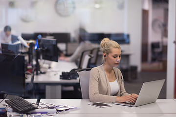 Image showing businesswoman using a laptop in startup office