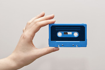 Image showing hand holding blue cassette tape