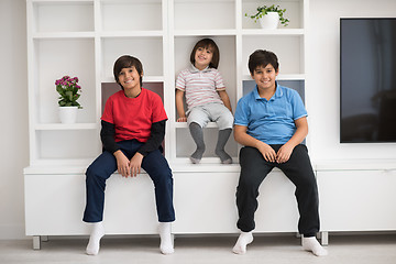 Image showing young boys posing on a shelf