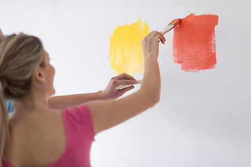 Image showing couple painting interior wall