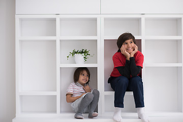 Image showing young boys posing on a shelf