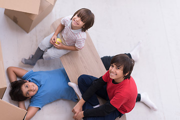 Image showing boys with cardboard boxes around them top view