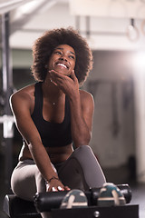 Image showing black woman doing sit ups at the gym