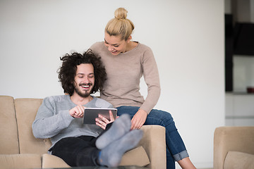 Image showing couple relaxing at  home with tablet computers