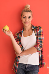 Image showing woman over color background plays with apple