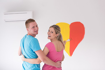 Image showing couple are painting a heart on the wall