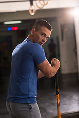 Image showing man workout with hammer and tractor tire