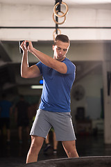 Image showing man workout with hammer and tractor tire