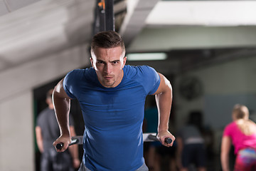 Image showing man doing exercises parallel bars