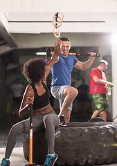 Image showing multiethnic couple after workout with hammer