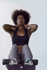 Image showing black woman doing sit ups at the gym