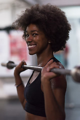 Image showing black woman lifting empty bar