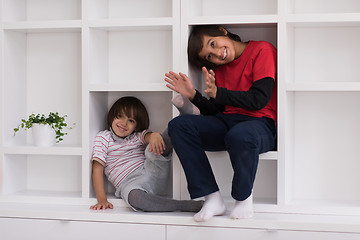 Image showing young boys posing on a shelf