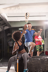 Image showing multiethnic couple after workout with hammer