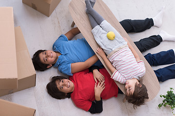 Image showing boys with cardboard boxes around them top view