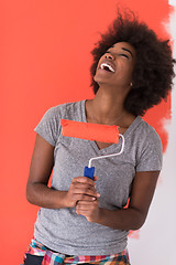 Image showing black woman painting wall