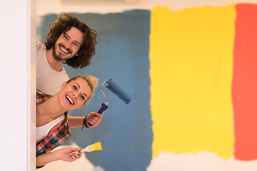 Image showing portrait of a couple painting interior wall