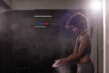 Image showing black woman preparing for climbing workout